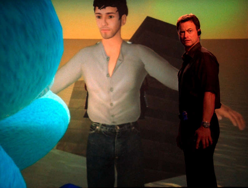 Det. Mac Taylor in front of a huge screen with one of
            his avis